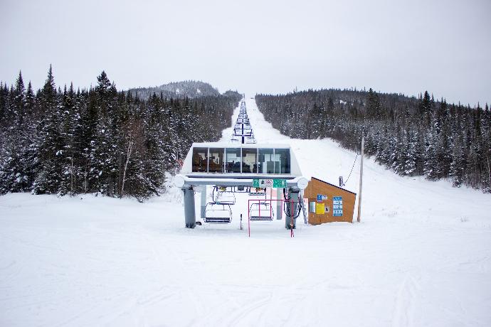 white and green wooden house on snow covered ground